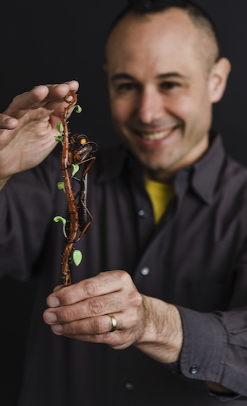 photo of Wesley Fleming holding glass sculpture